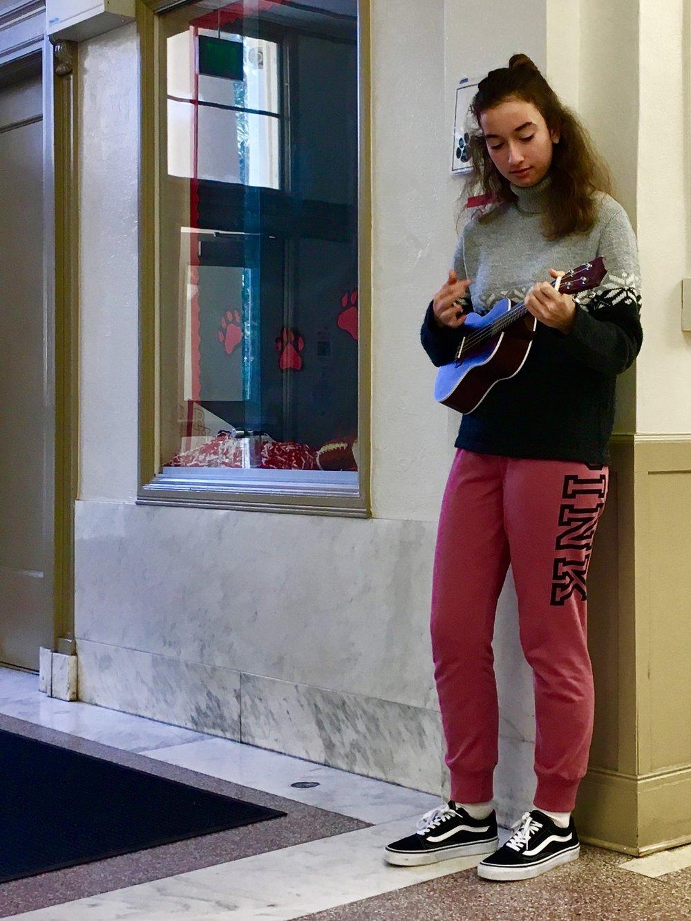  Lily Page jams out on the ukulele for fun. 