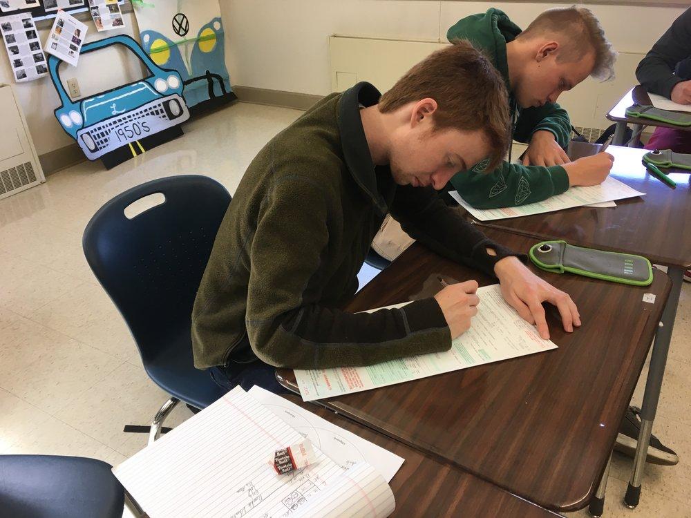  Seniors Max Schenk and Andrew Barrows fill out their voter registration form in Mrs. Liberatore’s sixth period AP Mircoeconomics class on March 23- the Day of Student Registration to Vote. 