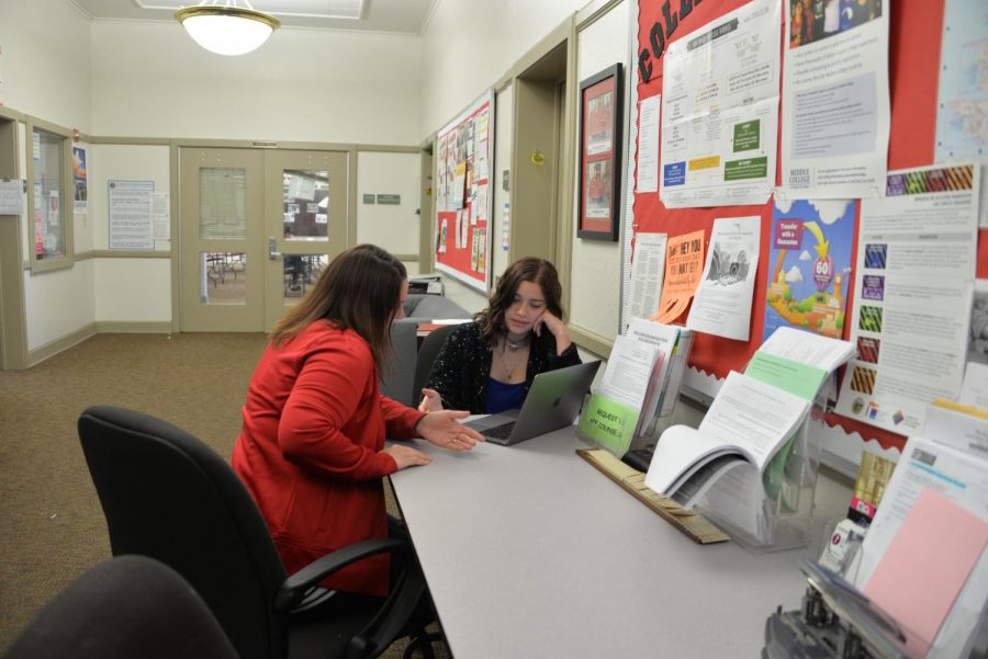 Senior Dana Rienks Alfaro converses with academic counselor Carla Renzi about committing to a college. The academic counseling department will continue to be a central college advice resource for AVID and non-AVID students next year.