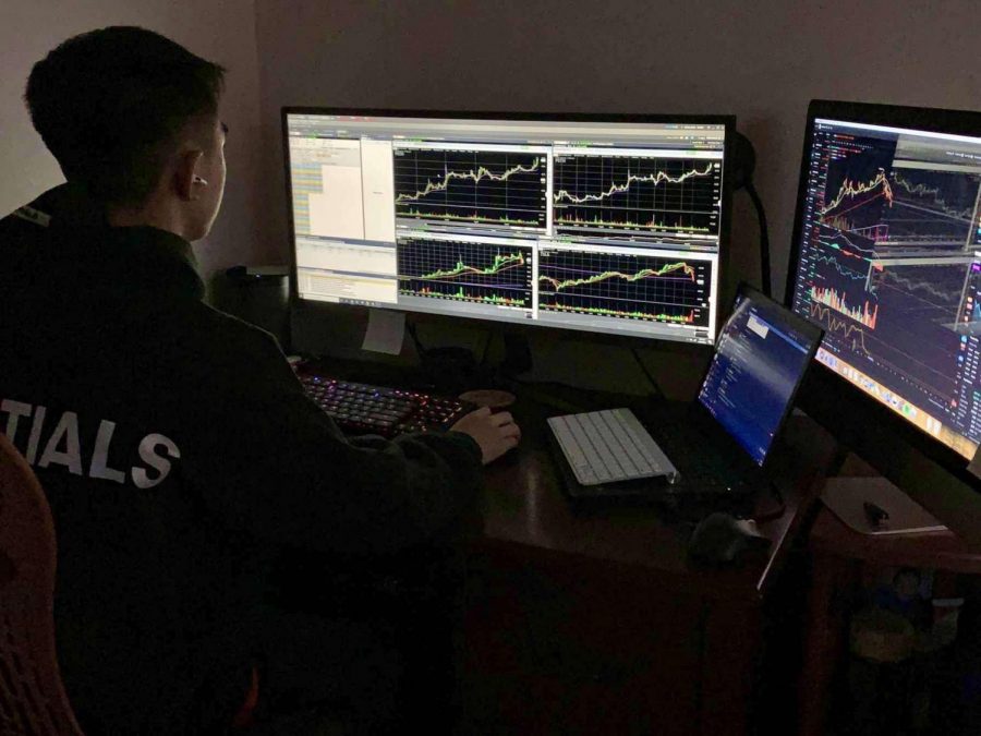 While examining stock charts, senior Brandon Fong searches for potential catalysts and patterns. He also draws support or resistance lines to help with his analysis. 