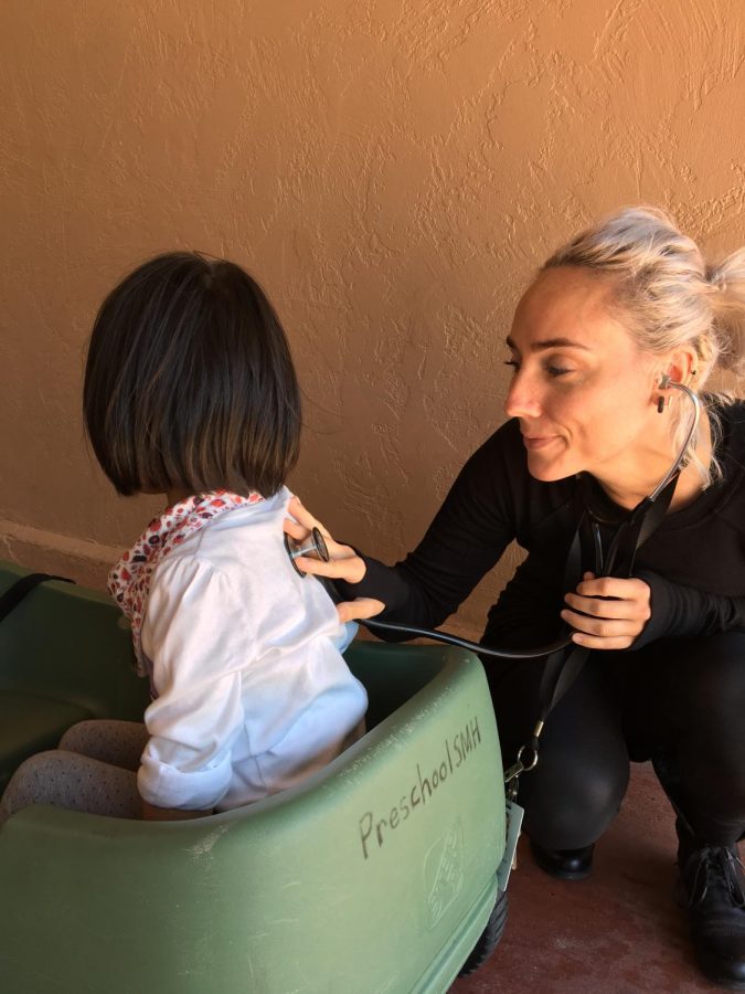 Marie Clarke, working as a school nurse in San Mateo, checks up on a young student.