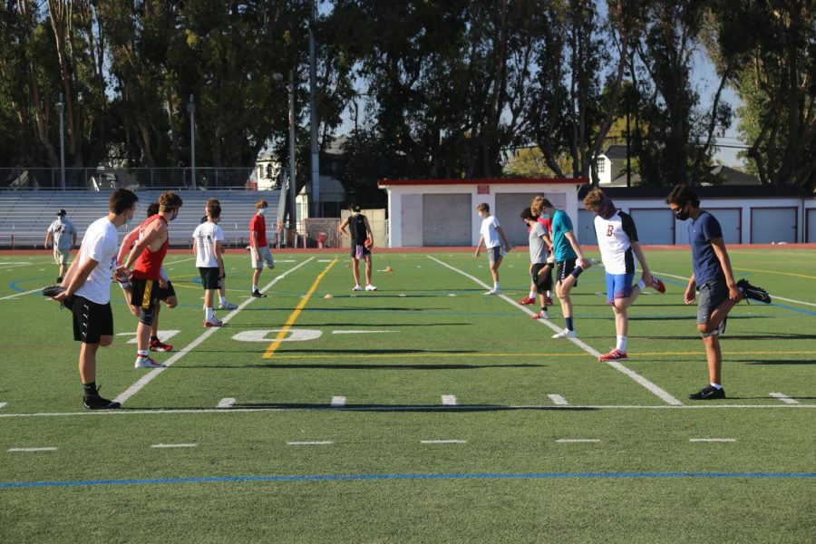 Burlingame football players stretch during their warm up on Oct. 15.
