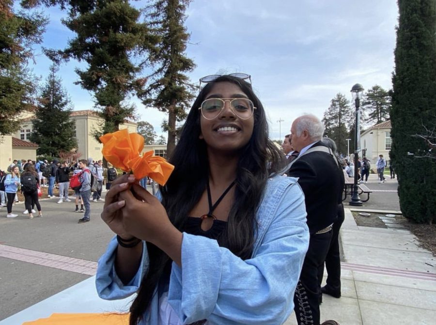 Current ASB President Neha Bandrapalli shows her school spirit during International Week as she poses with her paper flower on Jan. 31, 2019. 