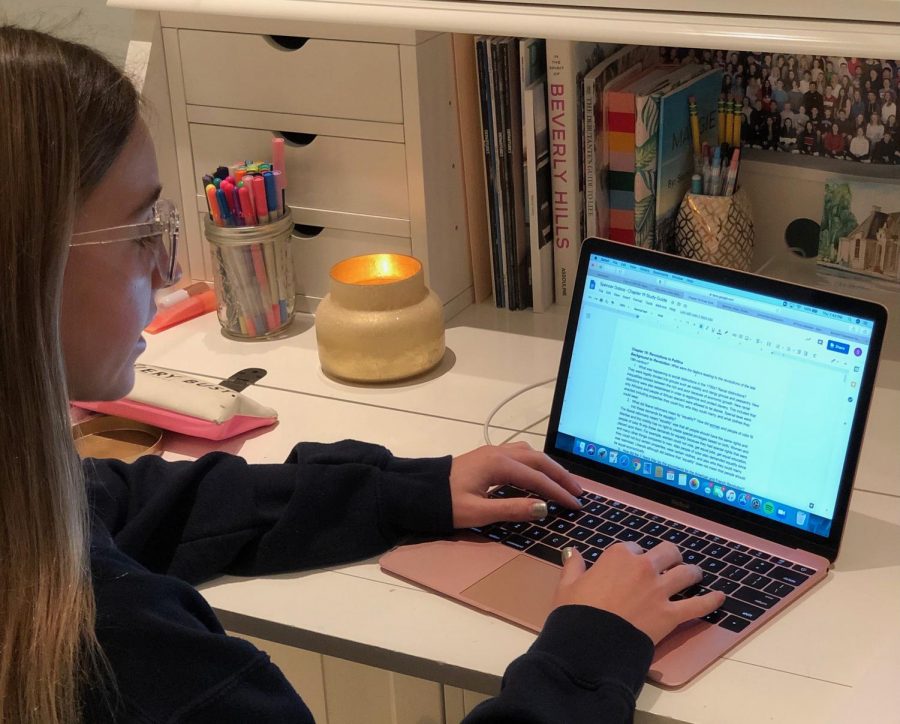 Sophomore Spencer Dobos wears her blue light glasses while doing homework.