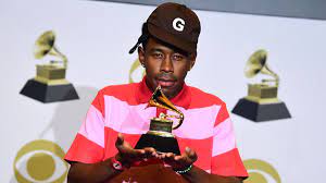 Tyler, the Creator at the 2020 Grammys with his award for Best Rap Album.