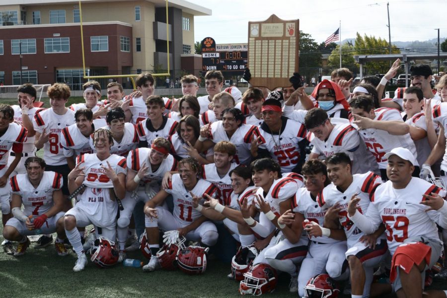 The varsity football team poses with the Little Big Game trophy, the Paw, after beating San Mateo High School in the Little Big Game