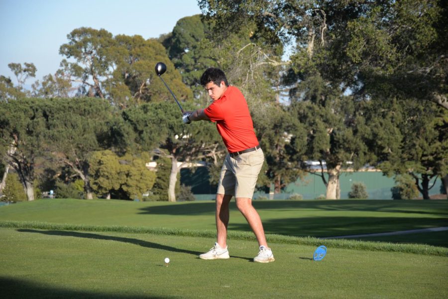 John Fitzgerald winds back to swing his club, taking his first shot of the hole during the team’s second match of the season against Hillsdale High School on Feb. 28. Burlingame went on to win the match, boosting the team to 2-0. 