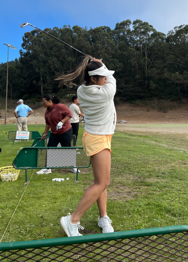 enior Brooklyn Arcenal drives the ball long distance in the girls’ golf practice at San Bruno Golf Center on Aug. 25.