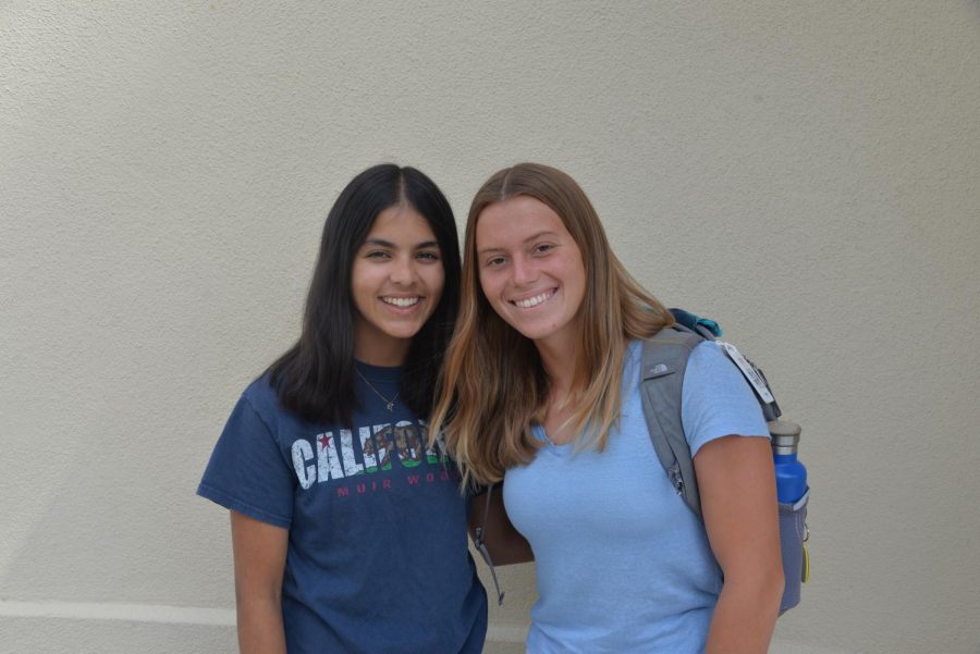 Seniors Sofia Husain and Kelsey McDonald, the new presidents of Burlingame Environmental Club, pose for a photo in front of the library at lunch.