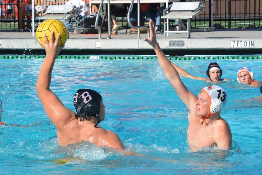 Senior starter Jonathan Kon prepares to fire a shot into the goal while a Half Moon Bay defender attempts to block the throw.