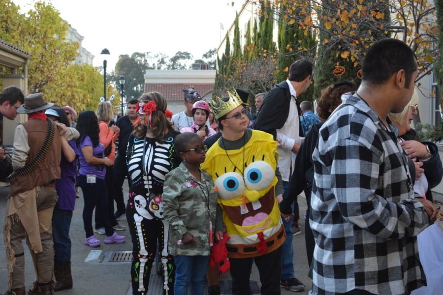 Bay University students dance in costumes outside the C-Building on Oct. 21.