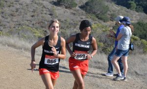 Freshman Stella Newman and Senior Minnoli Raghavan get to the top of cardiac hill after Newman’s long break at the two-mile mark.
