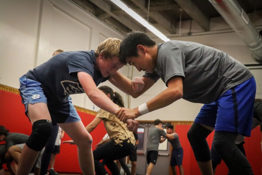 Leading boys’ wrestlers sophomore Quinn Jones and junior Ariuka Purev-Chang match up for sparring during a preseason practice on Thursday, Nov. 17.