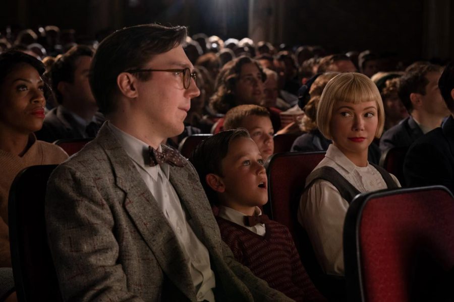 A young Sammy Fabelman (Gabriel LaBelle) watches his first movie along with his parents, Mitzi (Michelle Williams) and Burt (Paul Dano) Fabelman.