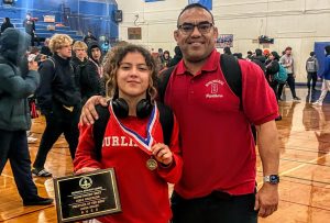 Sophomore Lauren Aguilar shows off her Peninsula Athletic League (PAL) wrestler-of-the-meet plaque and placement medal, following the PAL championship tournament in South San Francisco on Saturday, Feb. 4.
