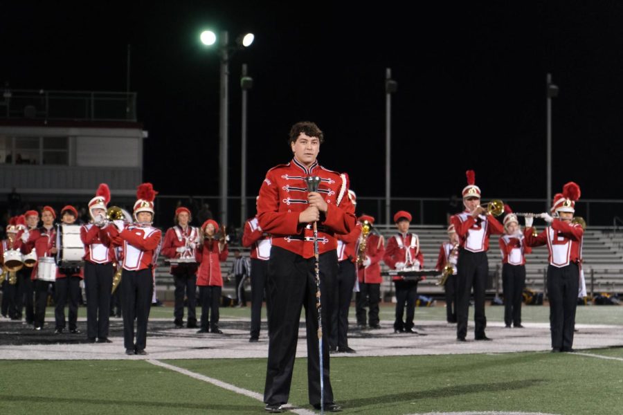 Jonathan Kon, one of the current drum majors, conducts the band at a football game. The drum majors lead the band and organize events, along with the help of the drum minors.