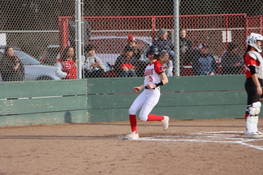Junior Olivia Fleming crosses the home plate in Burlingame’s season opener against Mills High School on Friday, March 3.