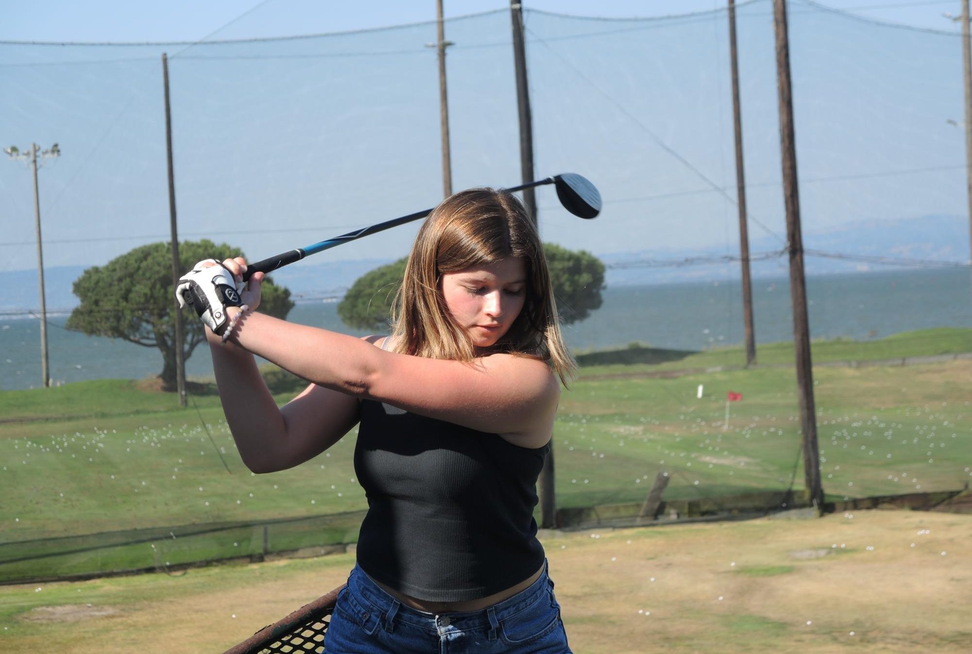 Junior Jennie Benaglia refines her swing at a team practice at the Mariners Point Golf Center in Foster City on August 23. 