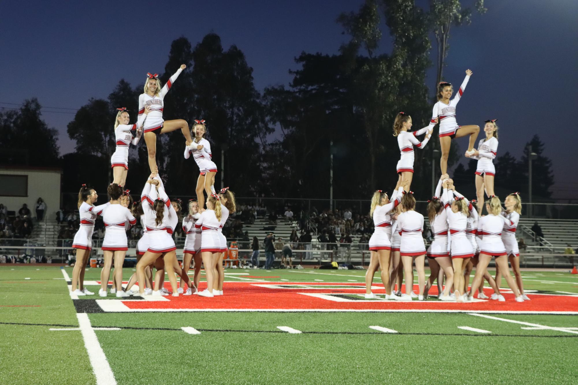 The cheer team executes a stunt to conclude the halftime performance at a football game against Capuchino High School on Aug. 25.