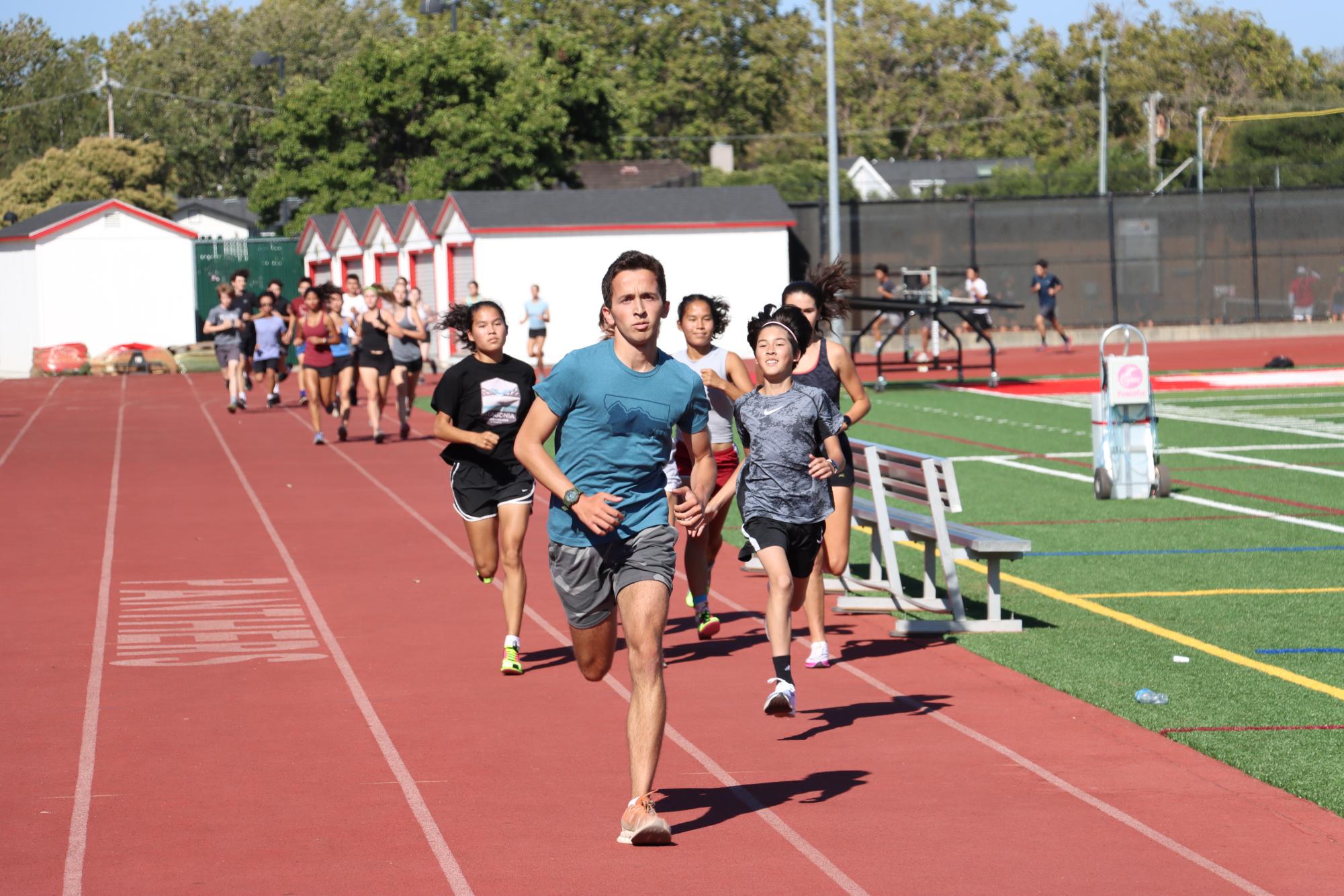 The cross country team sprints laps around the track during practice after school on Aug. 29 in preparation for their race.