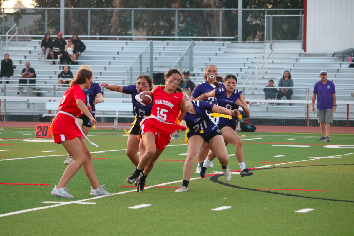 Senior slot receiver Kaylee Ng weaves her way through Sequoia’s defense. Although Ng sprinted into the endzone, the touchdown was called back based on an illegal flag guarding call.
