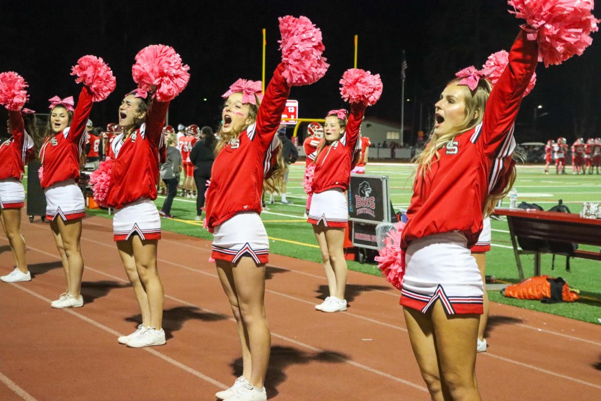 The cheer team chants their “Fight” song to keep the crowd energized and engaged throughout the game.