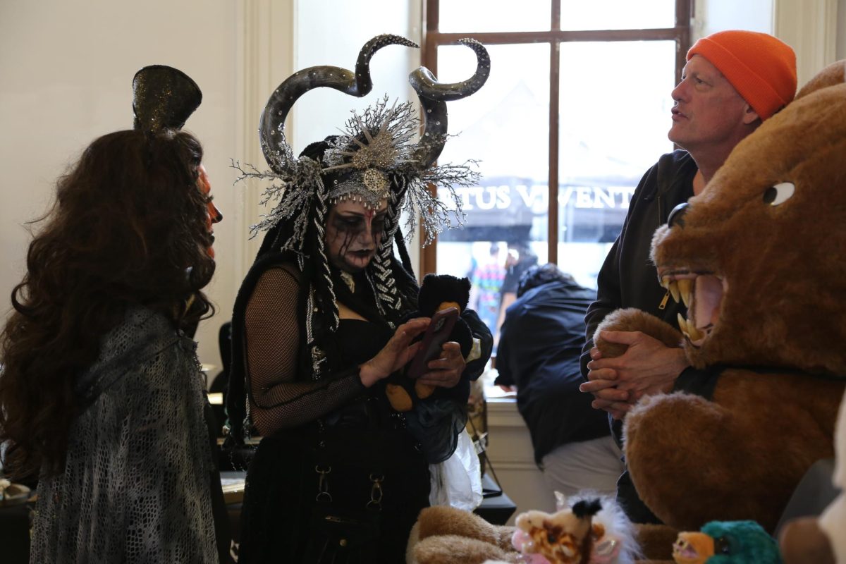 Attendee Jenny Jewels examines the eerie, sharp-toothed stuffed animal creations of vendor Matt Forristal.