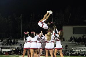 Sophomore Eva Mercer performs a flip in the air during halftime on Oct. 13 against Atherton. Such feats are susceptible to injury, and demand full mobilization to deliver. 
