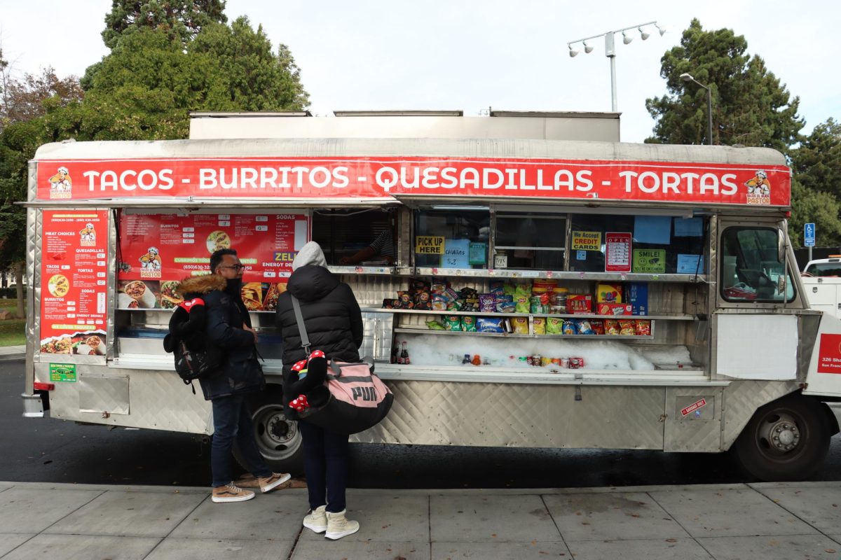 Customers line up in front of the new taco truck, “Tacos Al Buen Pastor” on Dec. 7. 