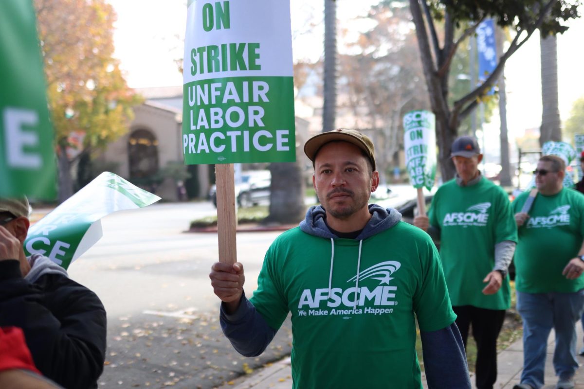 AFSCME members walked back and forth in front of Burlingame City Hall holding picketing signs.