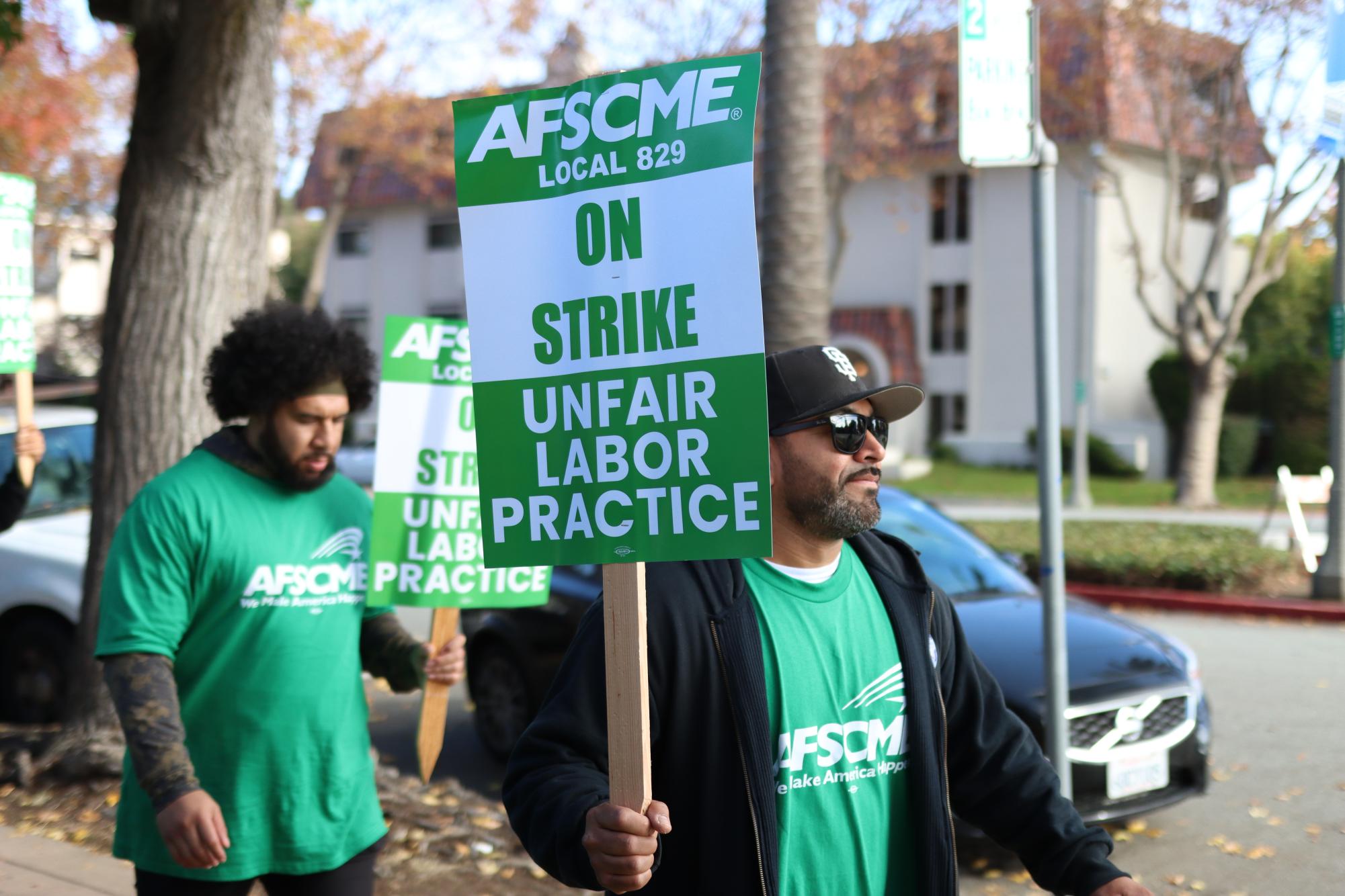 AFSCME members carried picketing signs.