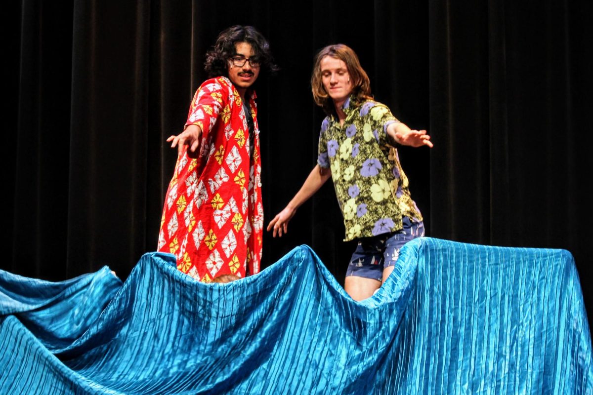 Students from advanced drama, acting as rival surfers, coast the waves onstage.
