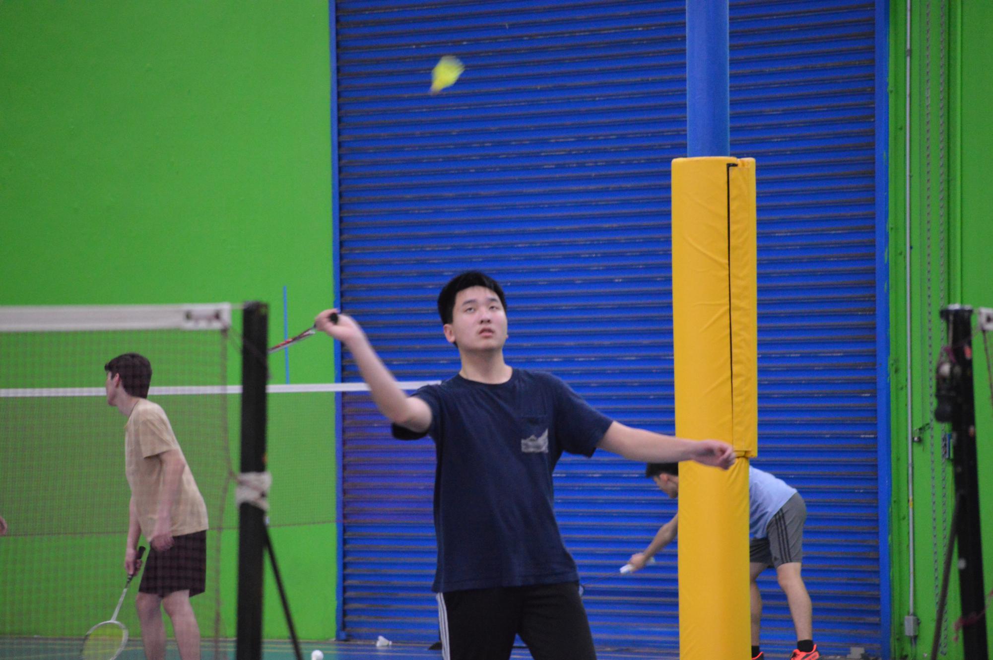Badminton players warm up, taking some shots during practice on Thursday, Feb. 22.
