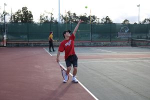 Junior Donovan Ranta prepares to serve over the net during practice on Wednesday, Feb. 21.
