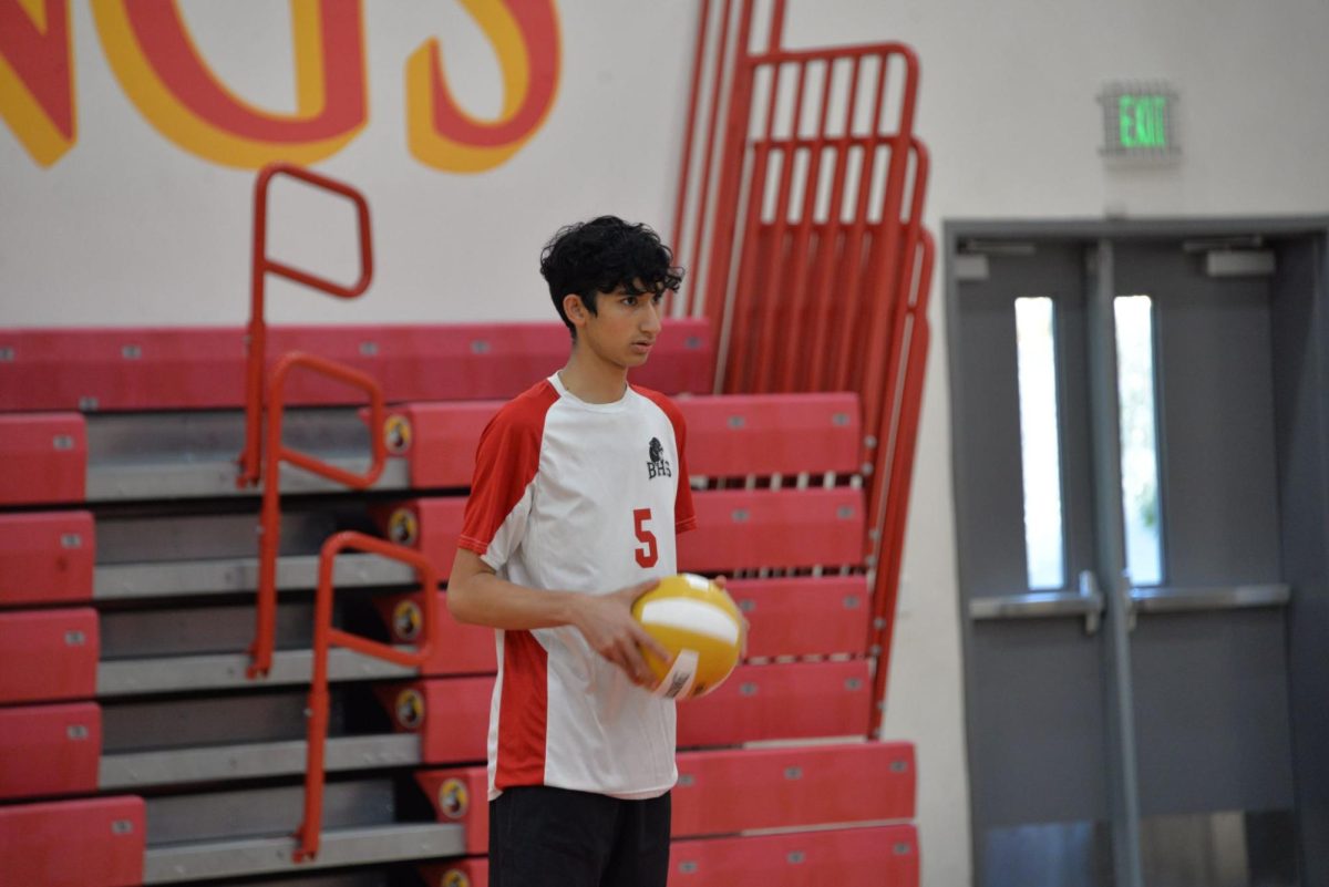 Junior Lucas Stuart awaits the whistle to serve during a match against Mills High School on March 15. 