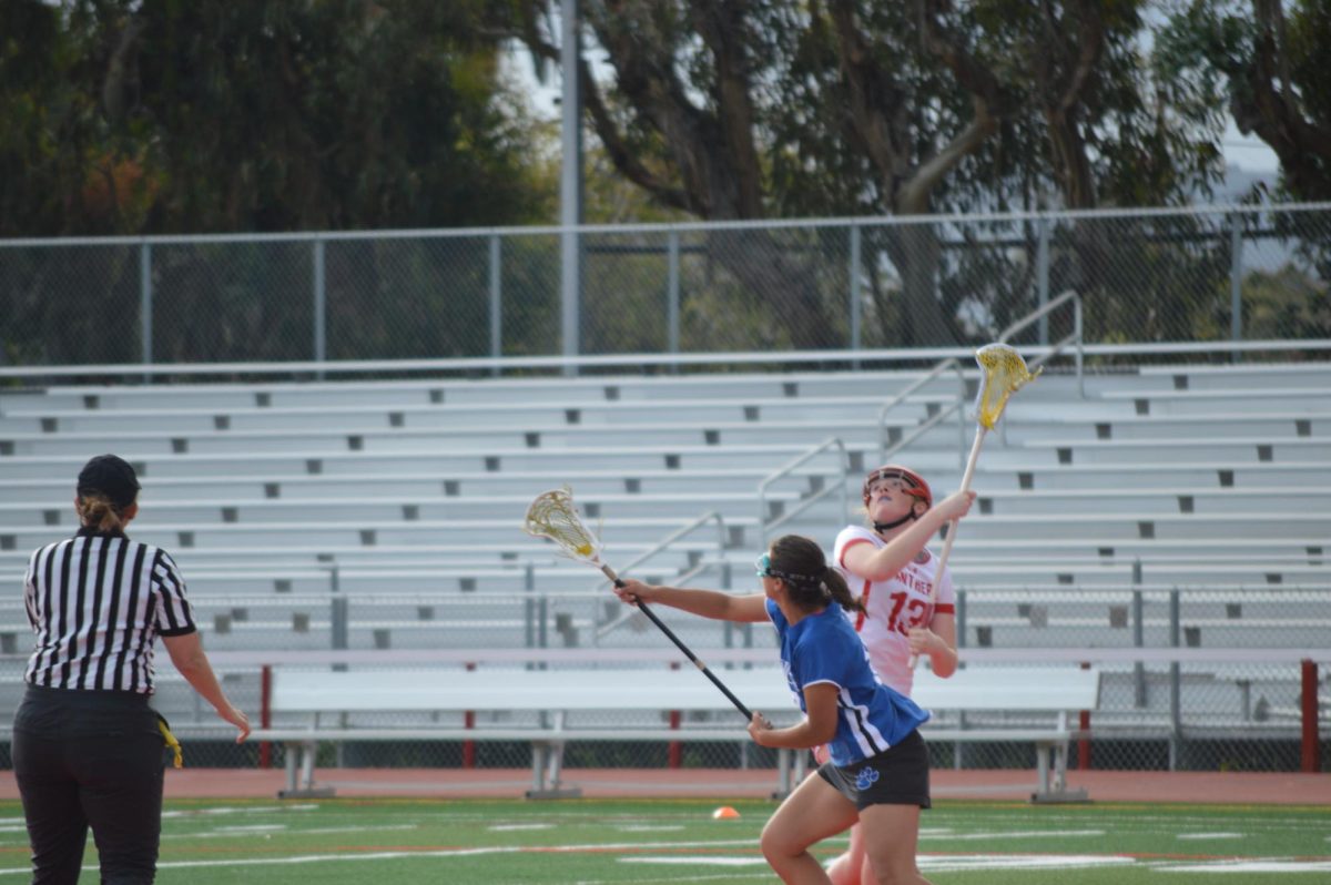 Sophomore Lila Edmondson fights for the ball on the draw 