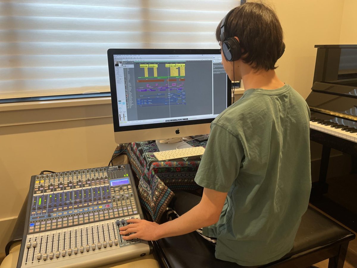 For most music producers, digital audio workstations (DAWs) are a necessity for mixing and polishing audio. Here, staff writer Bertelli is shown next to his DAW. While there is no shortage of highly capable DAWs on the market, prices for professional software typically range in the hundreds of dollars.