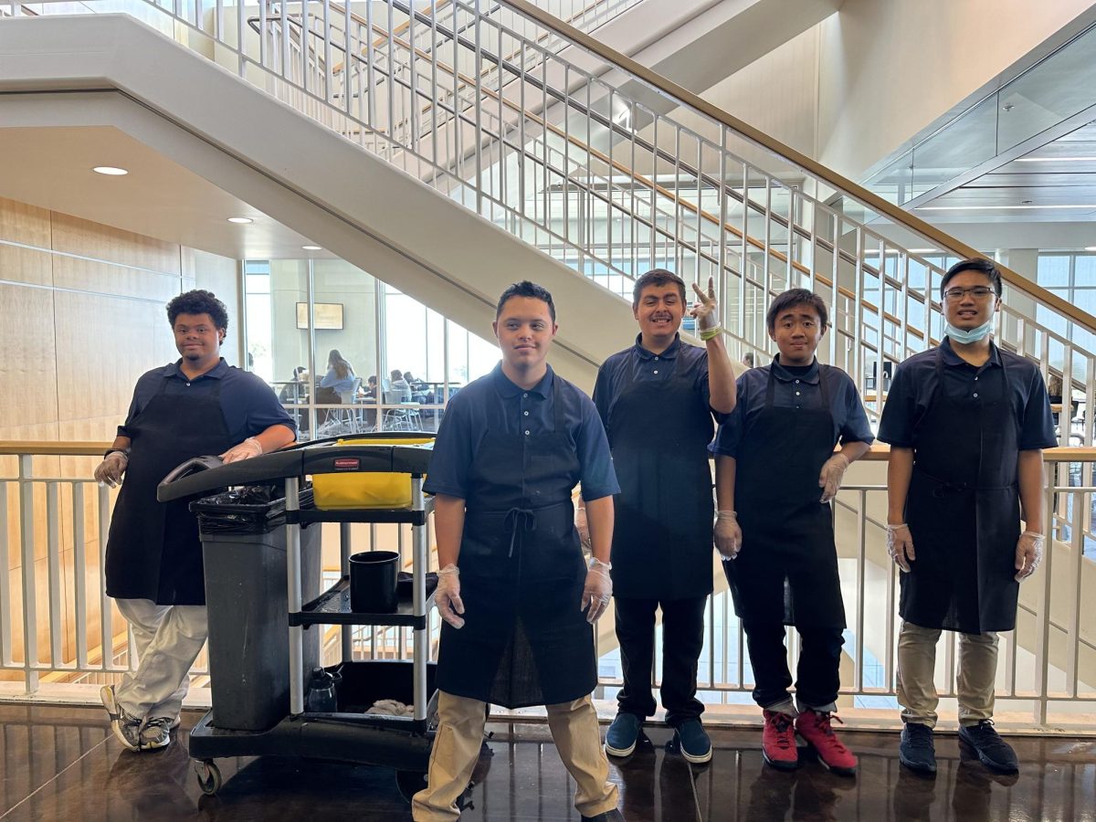 From left to right Bay Quest students Sam Morris, Matthew Frankel, Noah Curiel Miranda, Adrien Bernabe, Lemuel Ceralde pose for a picture while getting ready for work inside of the CSM Dining Center.