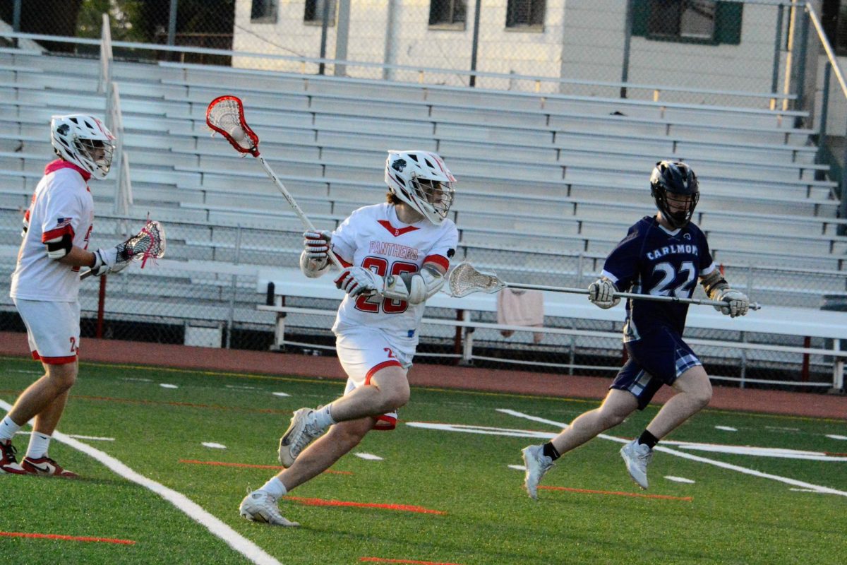 Junior Henry Bradley brings the ball down the field during the boys’ lacrosse game against Carlmont on Thursday, May 2.