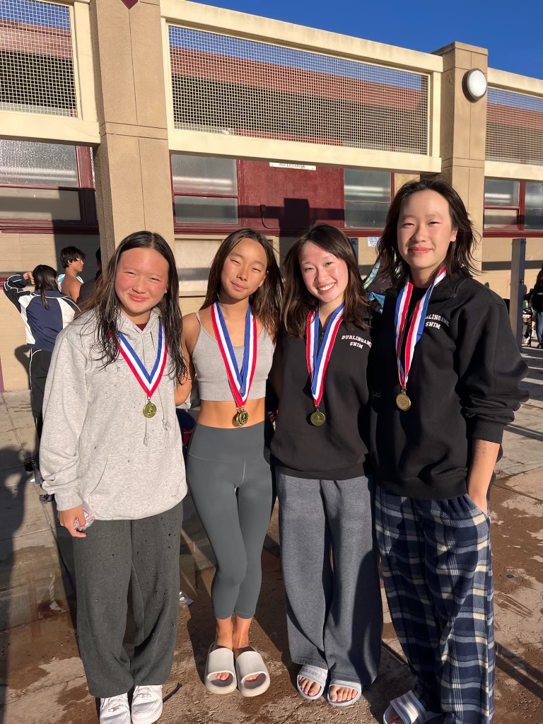 From left to right, freshman Alexa Chang, senior Sofia Kim, junior Karena Huang and freshman Katelin Huang pose for a picture after earning medals in their races.