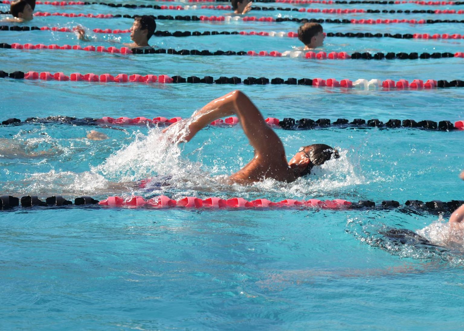 Players swim laps to continue developing strength, resilience, and consistency in the weeks before their first matches.