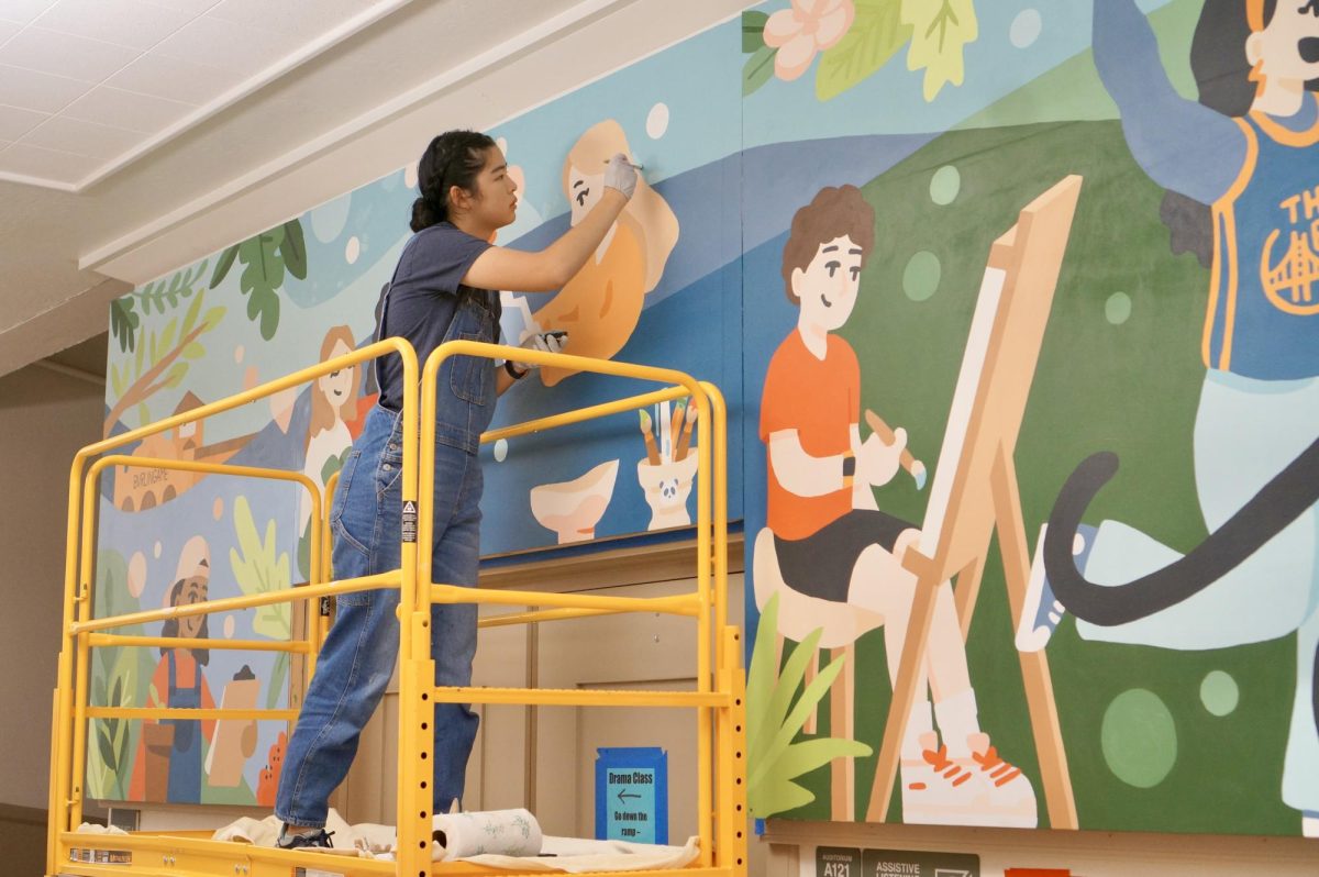 Cheng applies the final touches to the mural’s details on Saturday, Sept. 7.