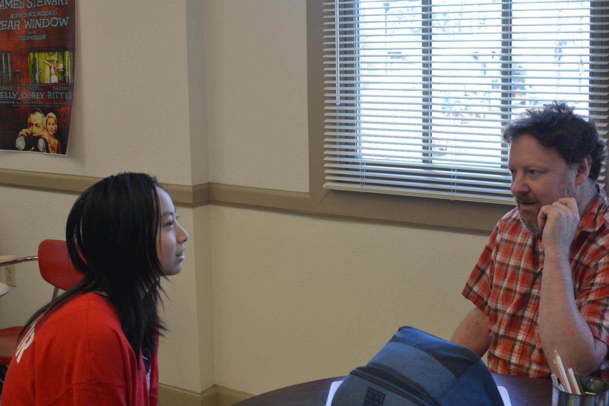 Senior Hannah Wen and Karshan discuss her flash fiction piece, the first writing assignment of the semester. Karshan holds meetings with each student to debrief their pieces.