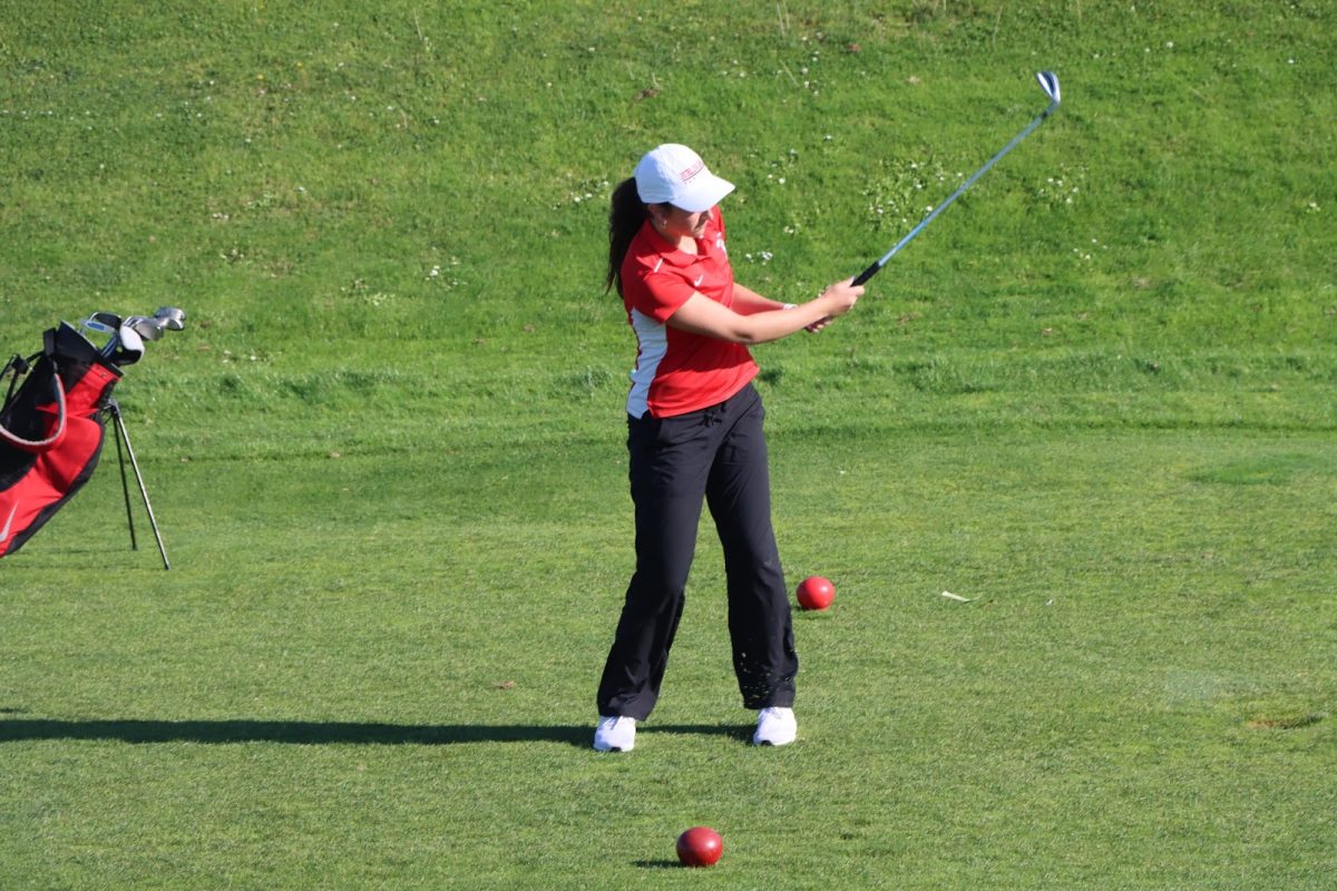 Senior Gigi Sullivan tees off on the eighth hole at Mariners’ Point Golf Course on Thursday, Sept. 19. 