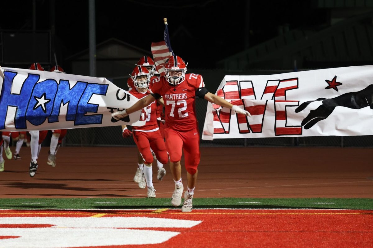 Senior lineman JJ Vea leads the team back onto the field for the second half during Burlingame’s game against Mountain View on Friday, Oct. 4.