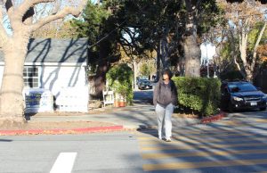 Burlingame freshman Marlon Garcia crosses the street amid post-school traffic. 