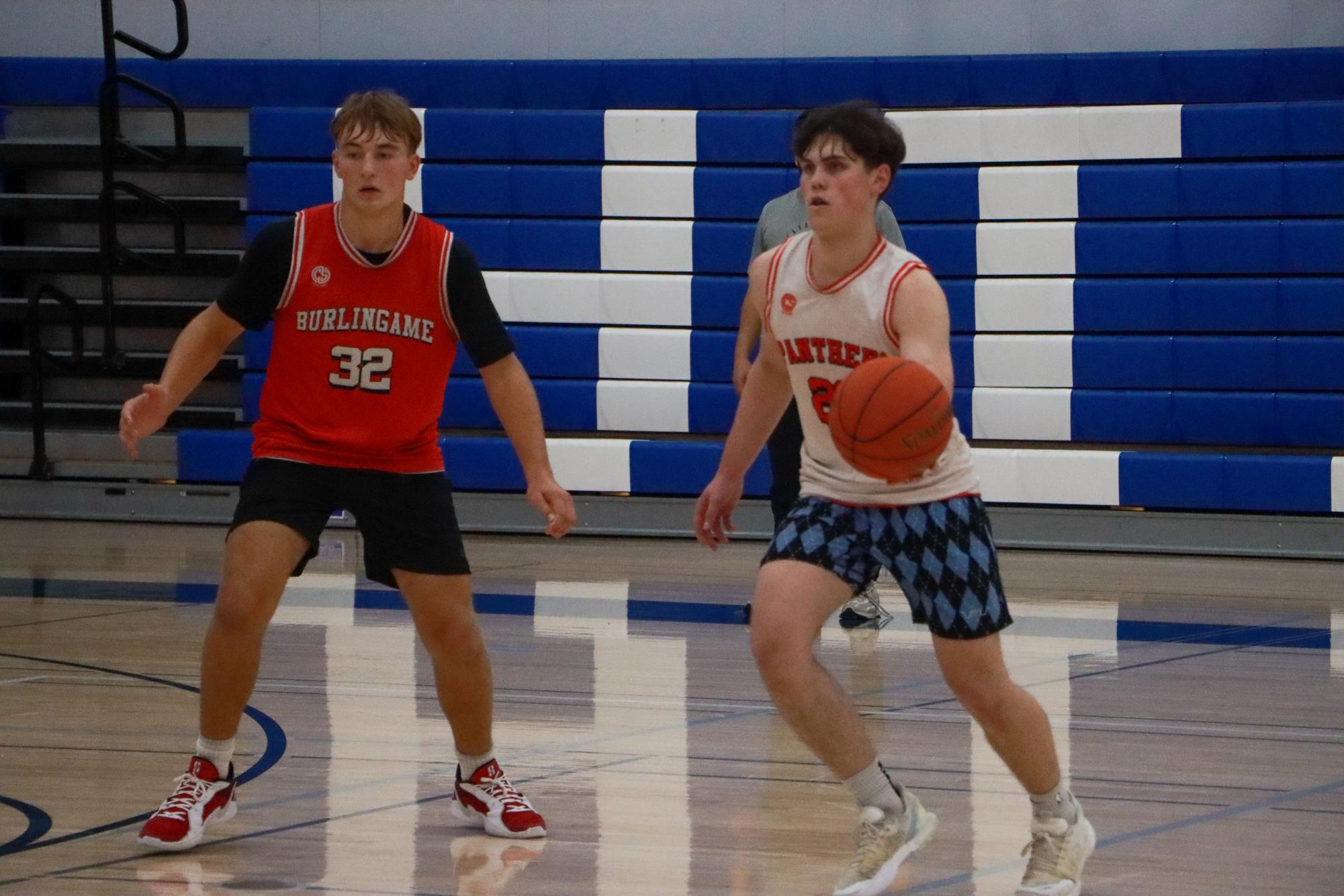 Junior point guard Payton Fong Heady tries to keep possession of the ball in a drill.