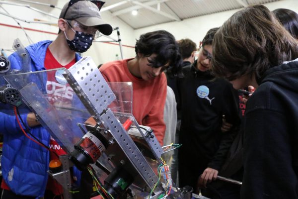  Engineering Training Lead Pranav Bajaj checks on one of the robot's mechanisms.