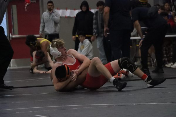 Junior Miles Davis wrestles his Woodside opponent in a third-place match on Saturday, Dec. 14.