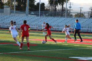 Sophomore Natalie Chen dribbles the ball on offense looking for an equalizing goal against Aragon High School on Tuesday, Jan. 28. 